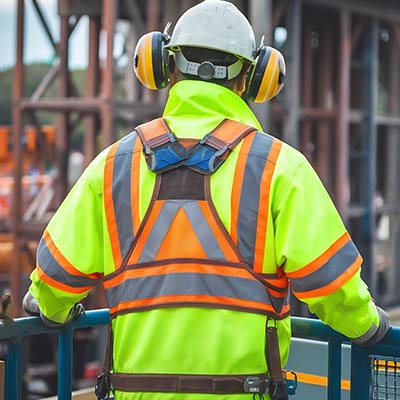 man standing in construction area wearing PPE